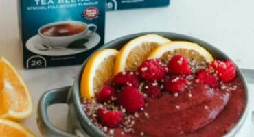 Smoothie bowl with mango, dragon fruit, berries and hemp seeds