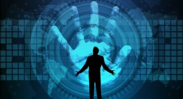 Silhouette of a man in a suit with outstretched arms against a digital background featuring a large hand and global motifs.