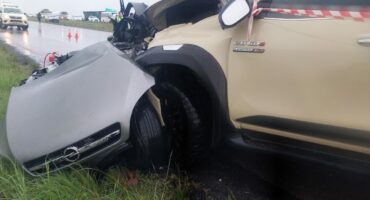 Accident scene where two vehicles, one silver and one khaki, can be seen.