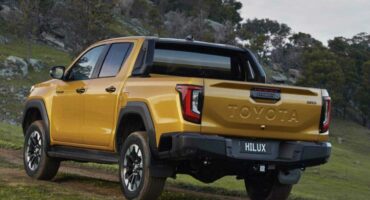 Mustard coloured Toyota Hilux double cab viewed from the back
