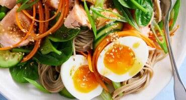 Soba noodle salad bowl with salmon fillets