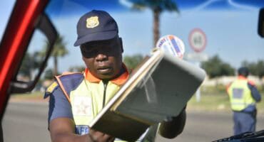 A traffic officer issuing a fine.