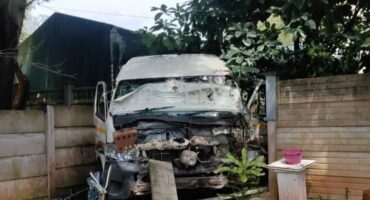 A taxi crash through a wall.