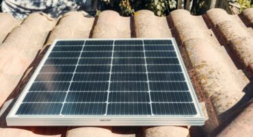 Solar panels on a red-brown roof.