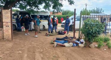 Suspects lying on the ground.