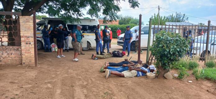 Suspects lying on the ground.