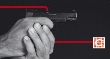 A man holding a firearm for illustration purposes only