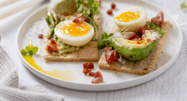 Smoky avo, bacon and soft egg on crisp melba