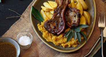 Crisp pork chops with creamy mashed butternut and potato wedges