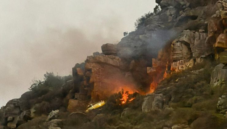 Fire and smike can be seen in the Table Mountain National Park after a helicopter crash