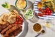 Sticky skewered pork belly served with a Mediterranean spread