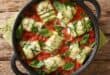 Baked zucchini rolls with ricotta cheese and herbs in tomato sauce