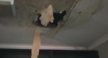 A blurry photo of a ceiling with a hole in it