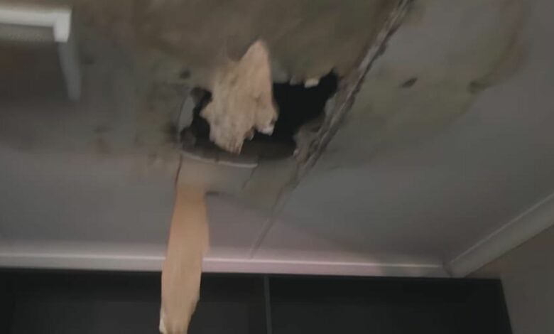 A blurry photo of a ceiling with a hole in it