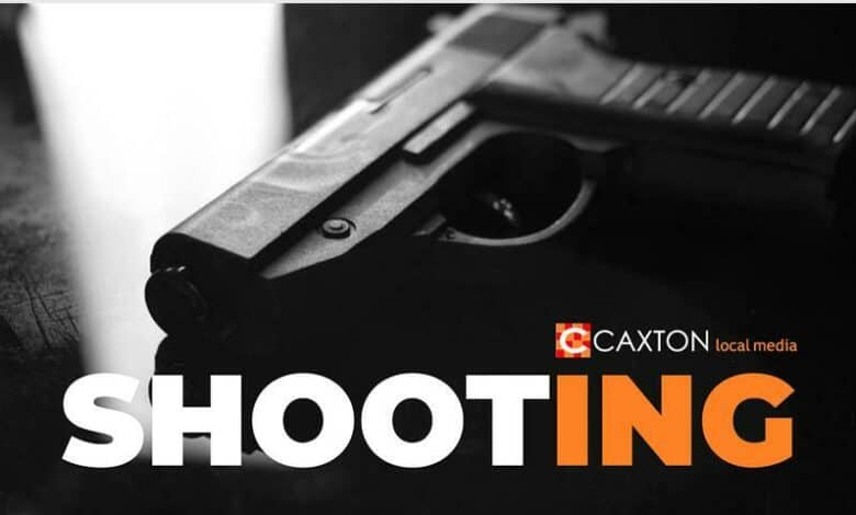 Photo of a pistol lying on a smooth dark surface with the word Shooting at the bottom of the image