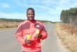 Coach next to road.