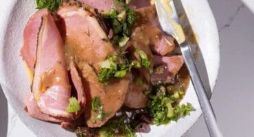 Peppered roast beef with herb and olive salsa