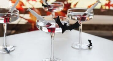 Elderflower and gin vampire cocktail with a blood-red syringe