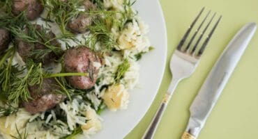 Swedish meatballs with dill, served over celery and spinach rice