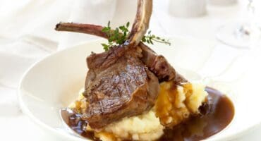 Pan-seared lamb cutlets with creamy mash and red wine gravy