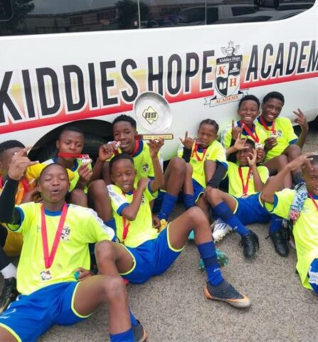 Kiddies Hope Academy crowned the Southern Central League Champions Description: Players in their sports gear with medals.