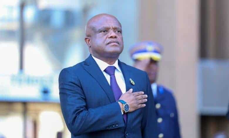 Respectful man in formal attire at a busy Soweto Urban event.