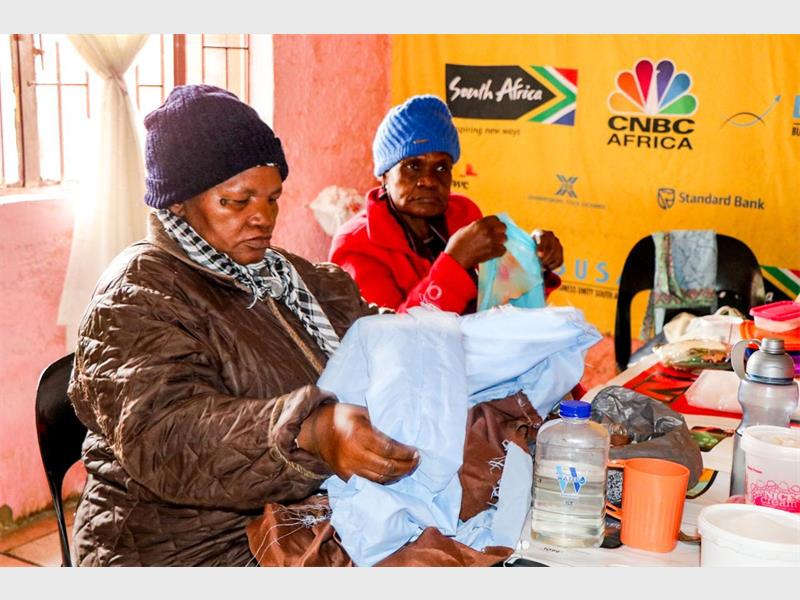 A local organisation has broadened its services to include a daily feeding scheme for schoolchildren while continuing to support elderly residents with meals and care programmes.