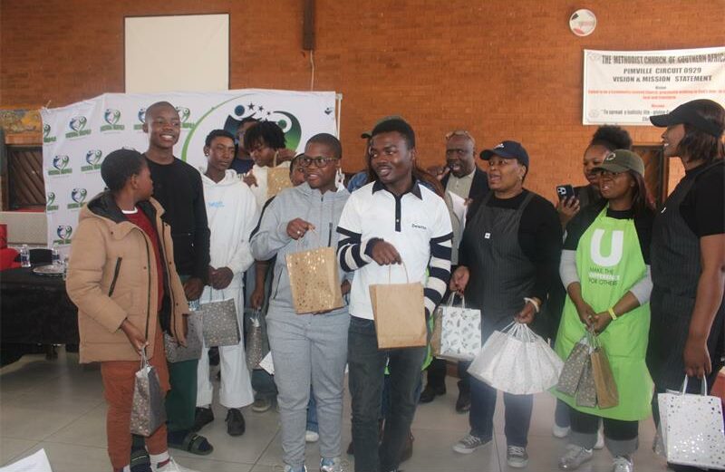 Young men received care packages and guidance during a community-focused Mandela Day initiative.