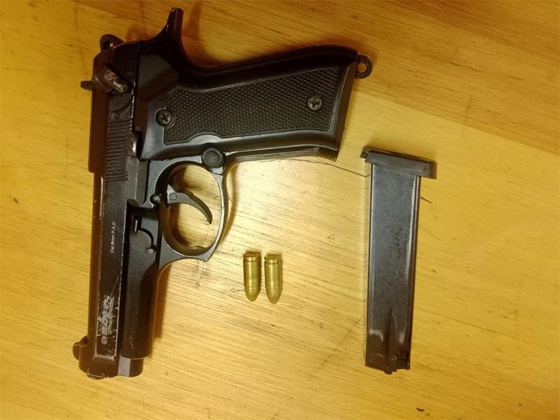 Police arrested an alleged suspect after finding a blank 9mm pistol and two live rounds of ammunition in his possession.