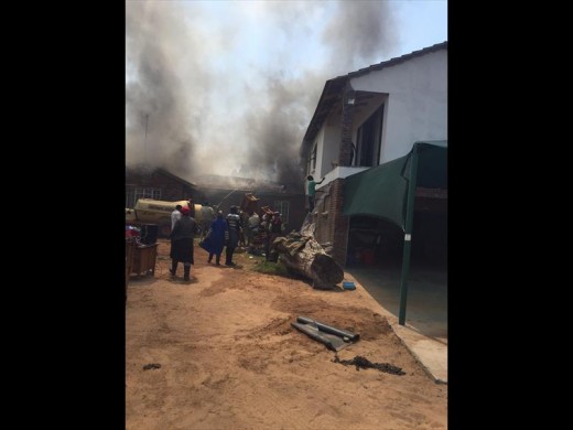 HELPING HANDS: Members of the community on the still smouldering scene of the fire.