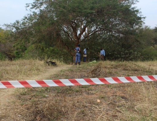 The body of a man surrounded by police.