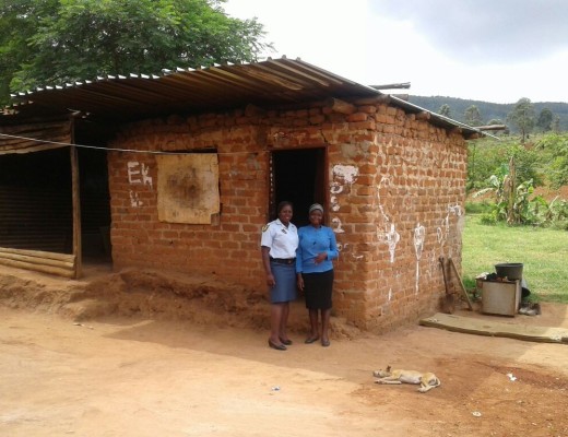Constable Millicent Mohale with Reneilwe Moyaba standing in front of the old house