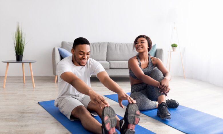 Fit,Black,Couple,Exercising,On,Yoga,Mats,At,Home,,Full