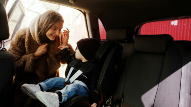 Young mother and child in car. Baby seat on chair. Safety drivin