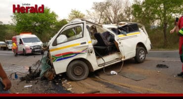 **Alt text:** Emergency responders assess the scene of a severe crash on the R36 near Morokolotsi Achaar Farm, where a damaged minibus taxi lies wrecked after a fatal collision involving a truck and a car.