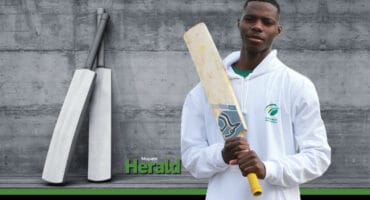 Ntshuxeko Sibatha posing with a cricket bat.