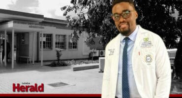 Dr Mikia Ramothwala in front of a background omage of Letaba Hospital.