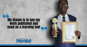 Dr Matome Malale holding his award.