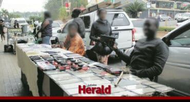 Street vendors in Tzaneen’s CBD display various goods on a sidewalk table as pedestrians pass by.