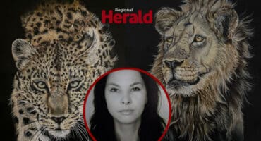 Juliette Venter with her two paintings in the background.