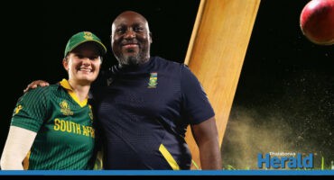 The Protea captain, and coach, smile for a picture. A cricket bat and ball are in the background.