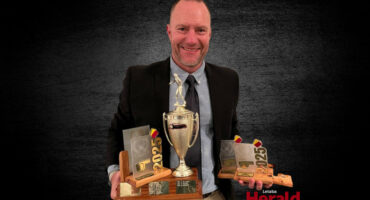 Neil Haarhoff hold his awards.