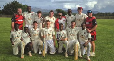 Ben Vorster's cricket team pose on the pitch.