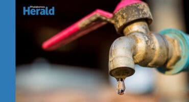 Water dripping out of a tap.