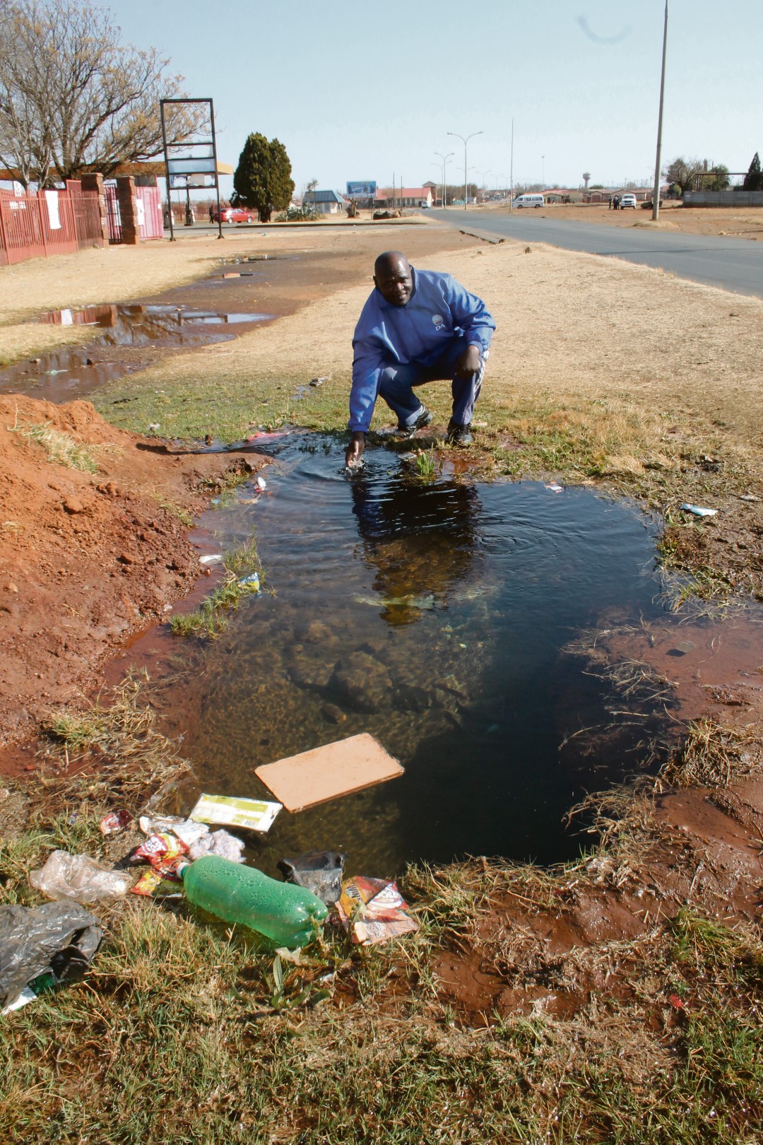 The hole on the sidewalk next to the community hall from where water had been leaking for the past two months.