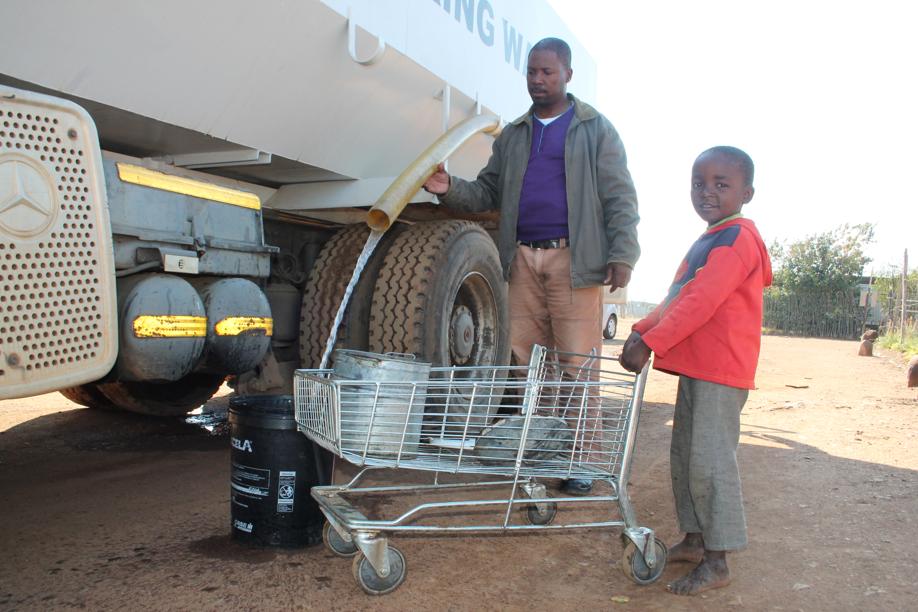 This municipal worker was busy helping to fill up residents water containers last week.