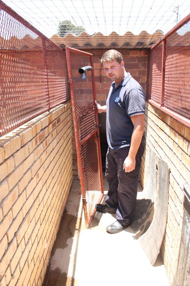 Mr DJ White of the Carletonville SPCA in one of the organisation's dilapidated kennels.