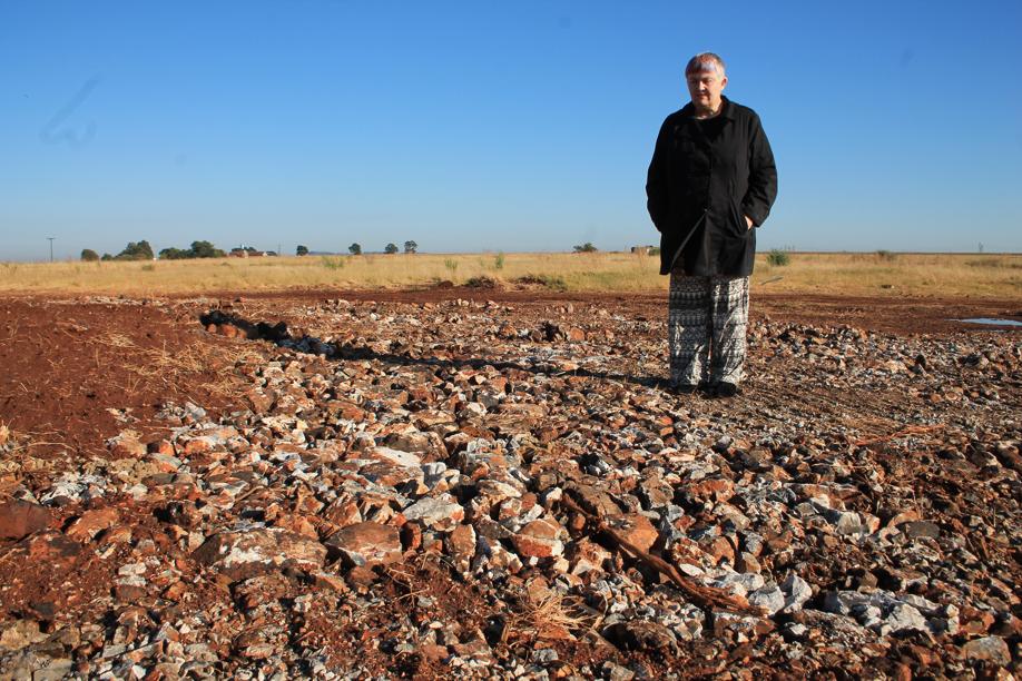 Ms Judy Rossouw at the site where the sinkhole had been filled up on the side of the road.