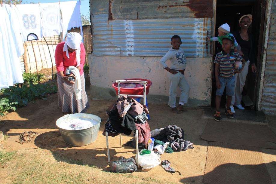 Some Kokosi Extension 99 residents using water they had gathered during the previous night.