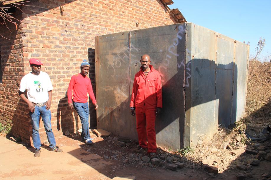 Concerned community members at the fridge that had been put up at the abandoned house before the owner left.